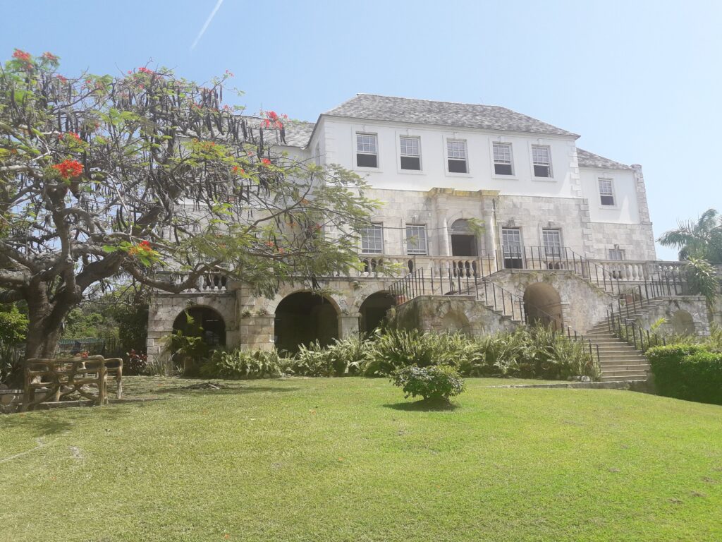 Historic Rose Hall Great House in Montego Bay, Jamaica, a Georgian mansion famous for the legend of Annie Palmer, surrounded by lush tropical gardens and overlooking the Caribbean Sea.