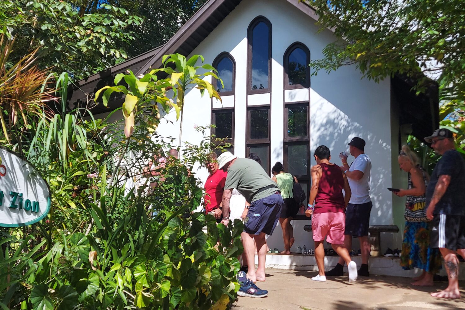 Visitors prepare to enter the mausoleum at Nine Mile, part of the Bob Marley attraction in Jamaica.