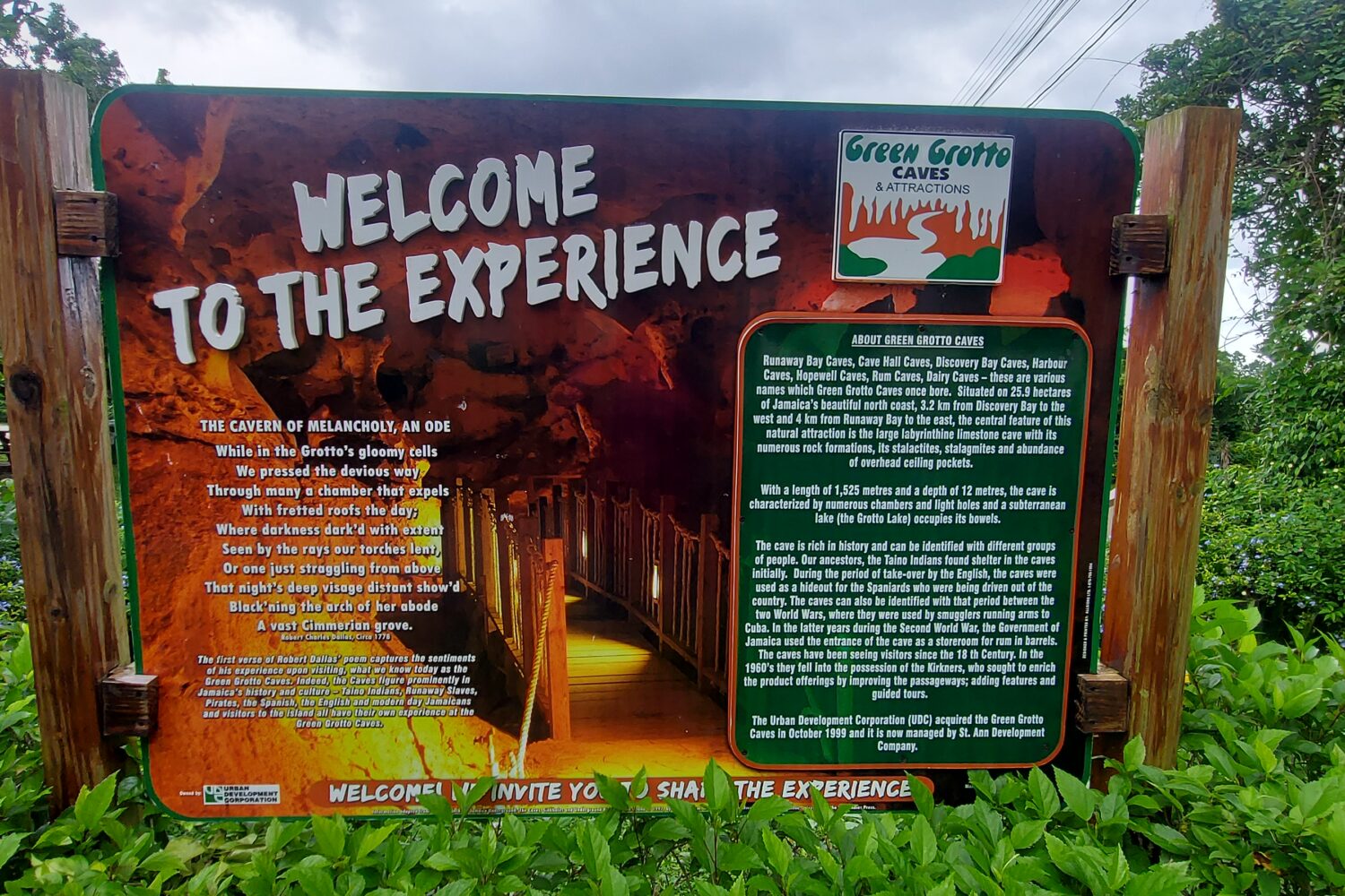 Vibrant signboard at Green Grotto Cave inviting visitors with the words ‘Welcome to the Experience.