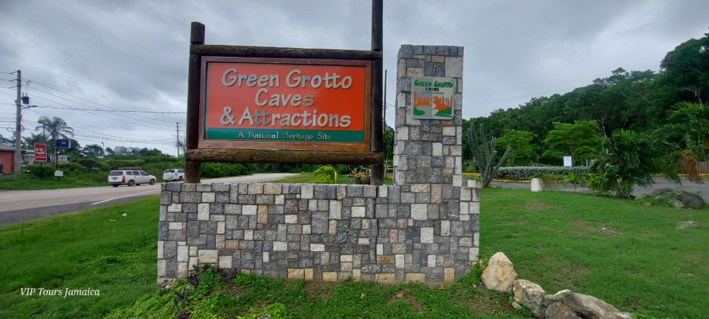 Green Grotto Caves roadside sign positioned across from the entrance to the attraction.