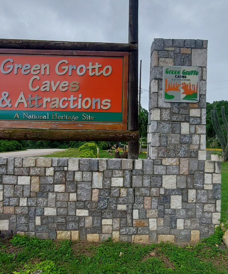 Green Grotto Caves roadside sign positioned across from the entrance to the attraction.