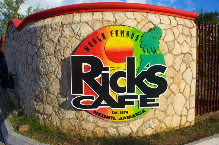 Rick’s Café logo sign displayed on the wall at the property entrance in Negril, Jamaica.