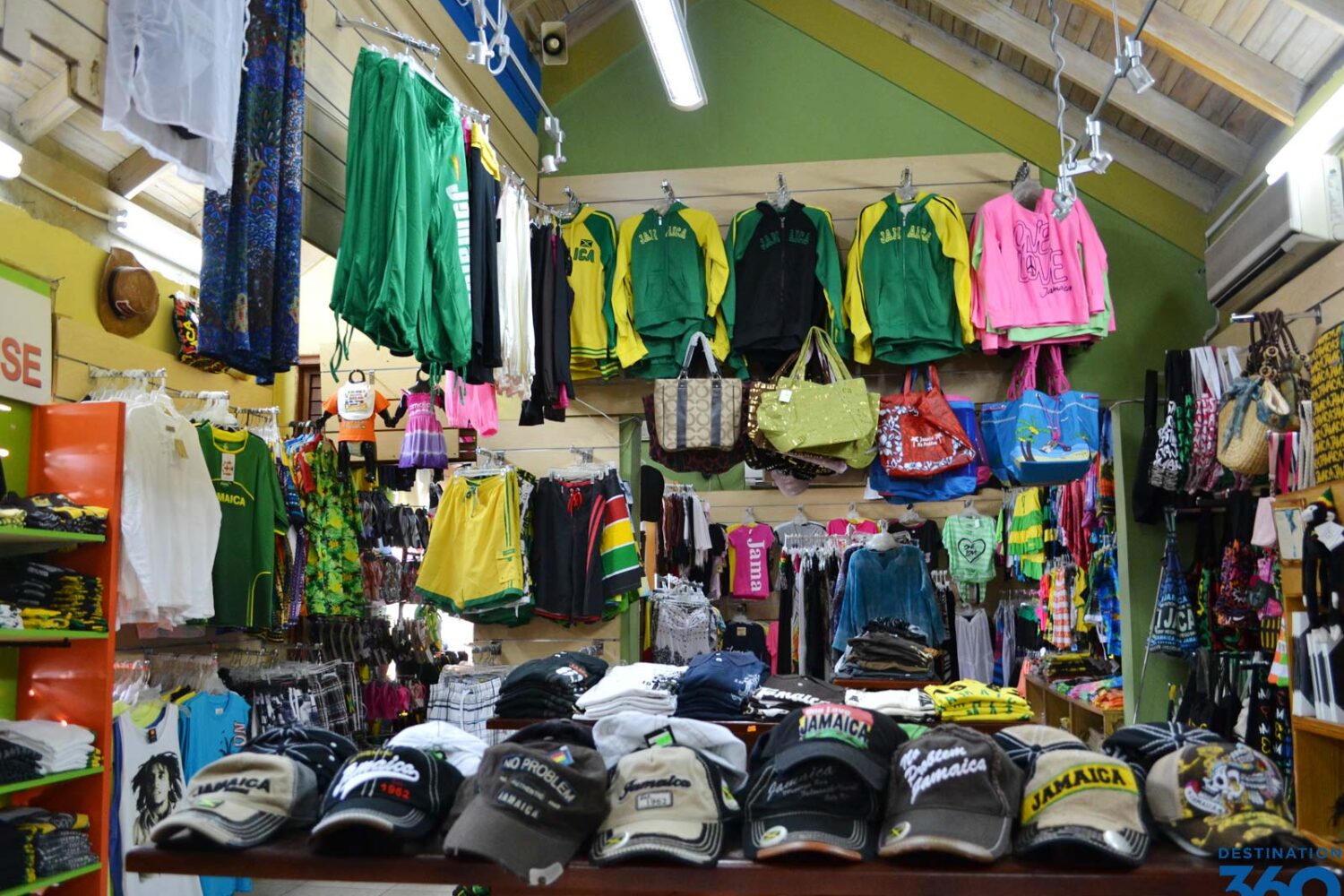Duty‑free shop in Montego Bay displaying colorful t‑shirts, souvenirs, and Jamaican merchandise.