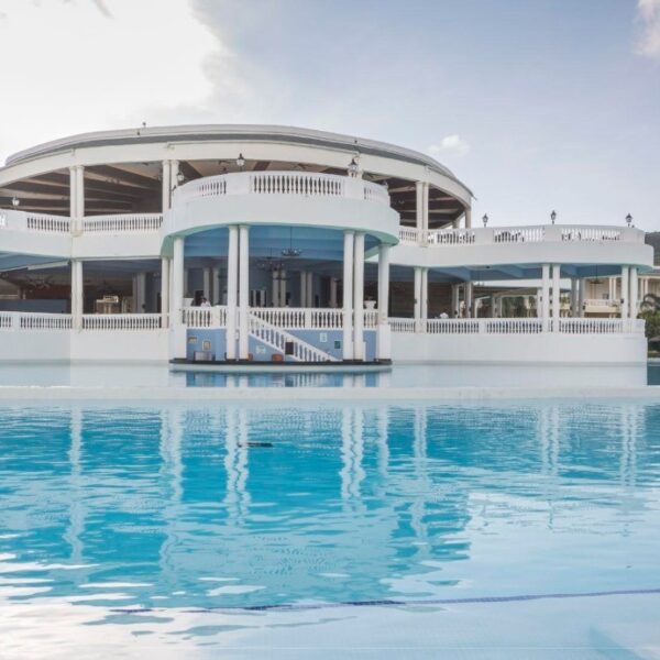 Elegant Grand Palladium Resort surrounded by tropical gardens and shimmering pools.