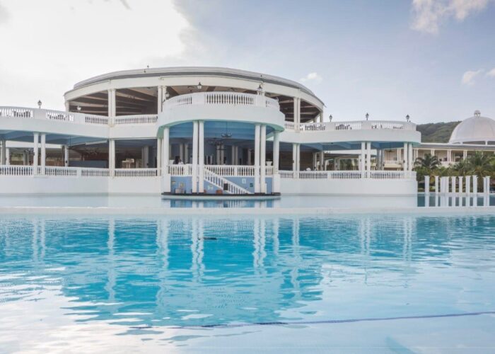Elegant Grand Palladium Resort surrounded by tropical gardens and shimmering pools.