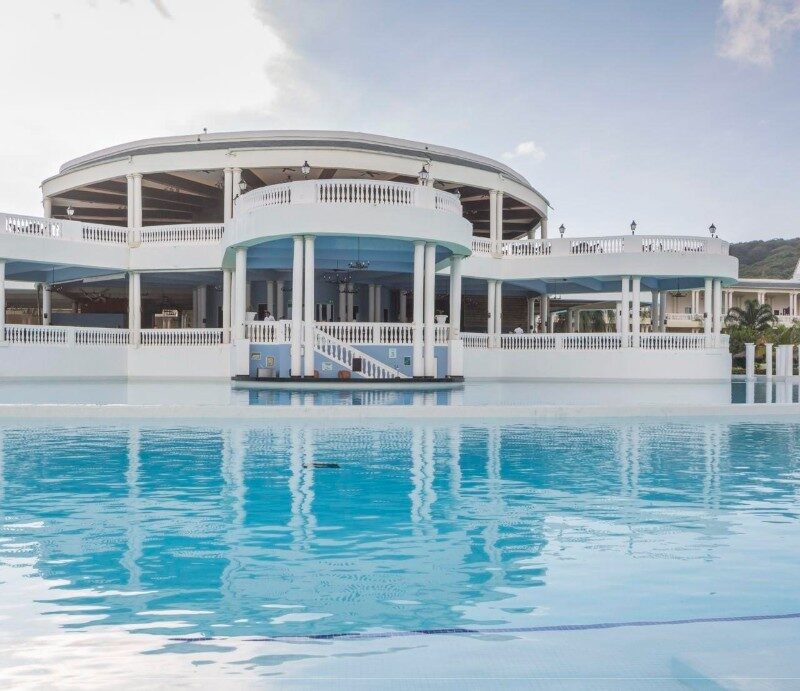 Elegant Grand Palladium Resort surrounded by tropical gardens and shimmering pools.